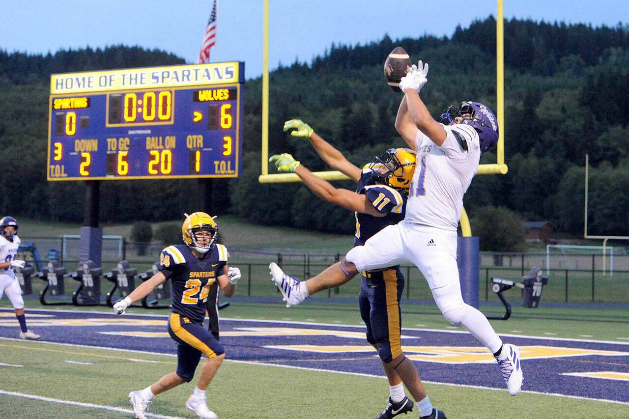 This Sequim pass to the Wolves’ Liam Wiker, No. 11 in white, was deflected by Forks’ Cash Barajas, No. 11 in navy blue, then intercepted by the Spartans’ Kingston Steffen and returned out to midfield. The Wolves held on in the closing moments for an 18-14 win on the Spartan Stadium turf.
Lonnie Archibald/for Peninsula Daily News.