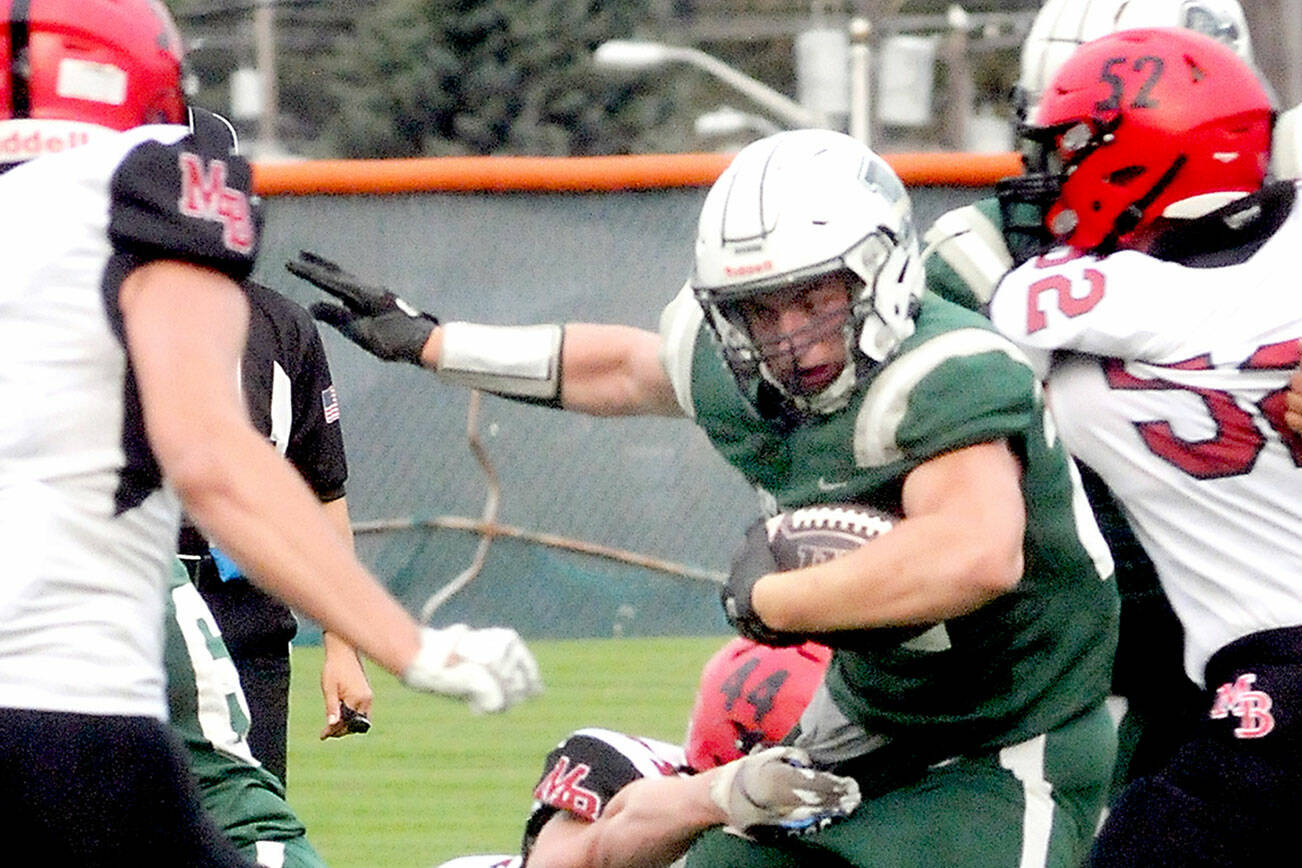 KEITH THORPE/PENINSULA DAILY NEWS
Port Angeles running back Dylan Mann, center, tries to evade the tackle by Mount Baker's Kamden Moa during Friday evening's game at Port Angeles Civic FIeld.