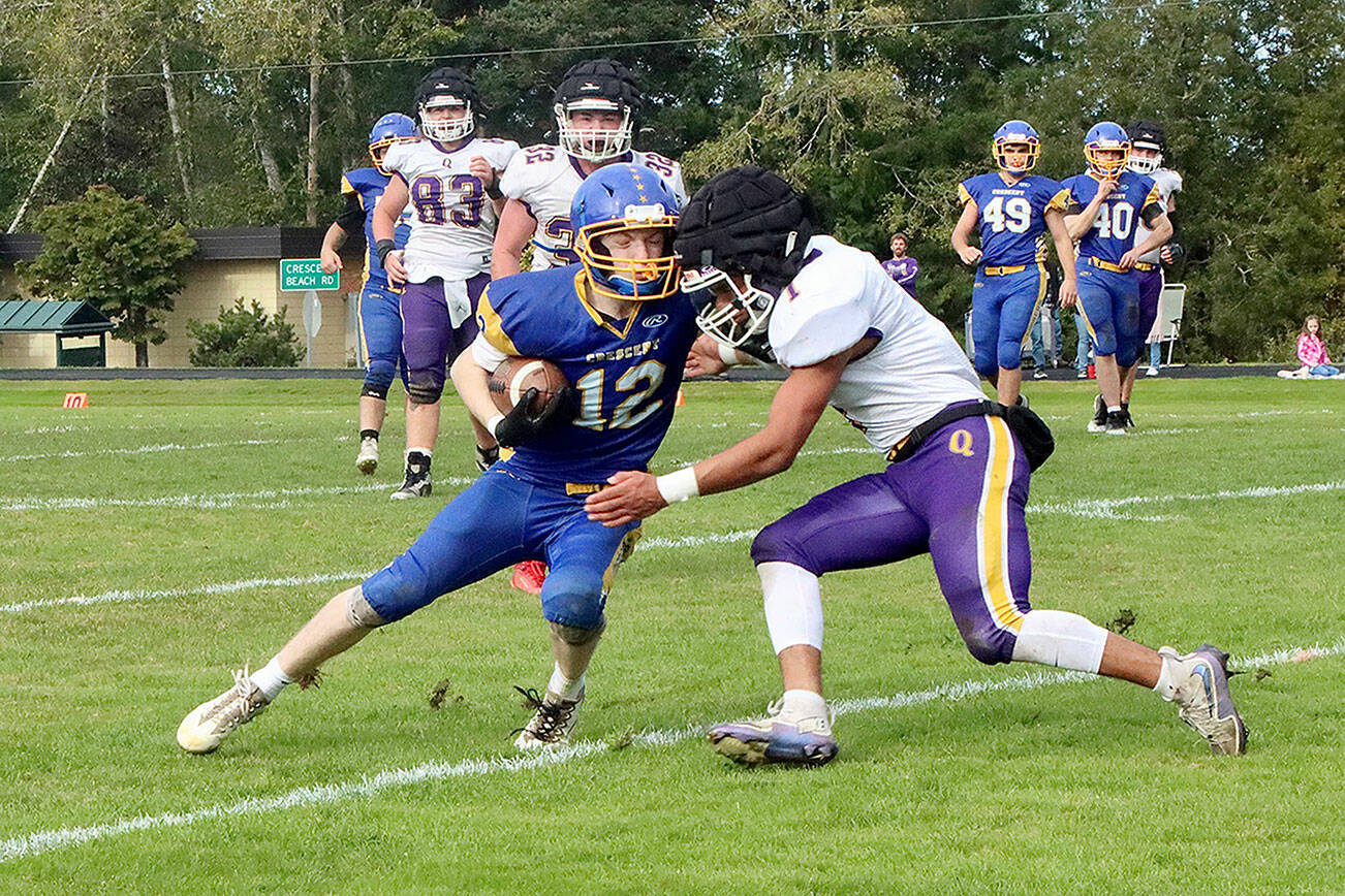 Crescent Logger #12 Mikah Love is met head on with Quilcene’s #1 Andrew Perez-lopez. Note that Quilcene is wearing the guardian caps for added protection on plays such as this. Q #83 is Taylor Boling. Q #32 is Mason Iverson. C #49 is Connor Avertt. C #40 is Caden Seedorf. dlogan