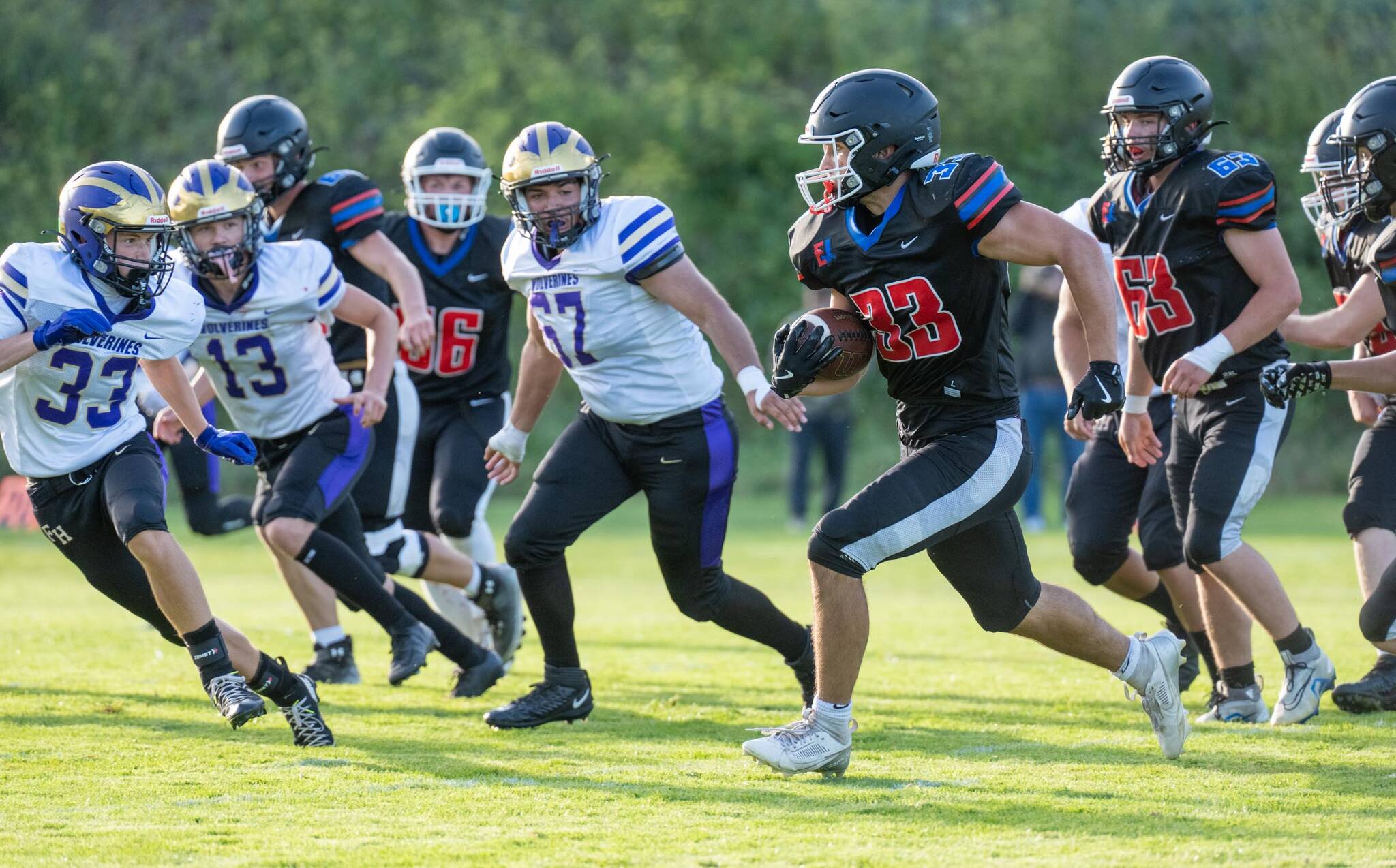 East Jefferson's Luke O'Hara runs a gauntlet of Friday Harbor defenders during a Friday night non-league game played against Friday Harbor in Port Townsend's Memorial Field. East Jefferson won 14-13. (Steve Mullensky/for Peninsula Daily News)