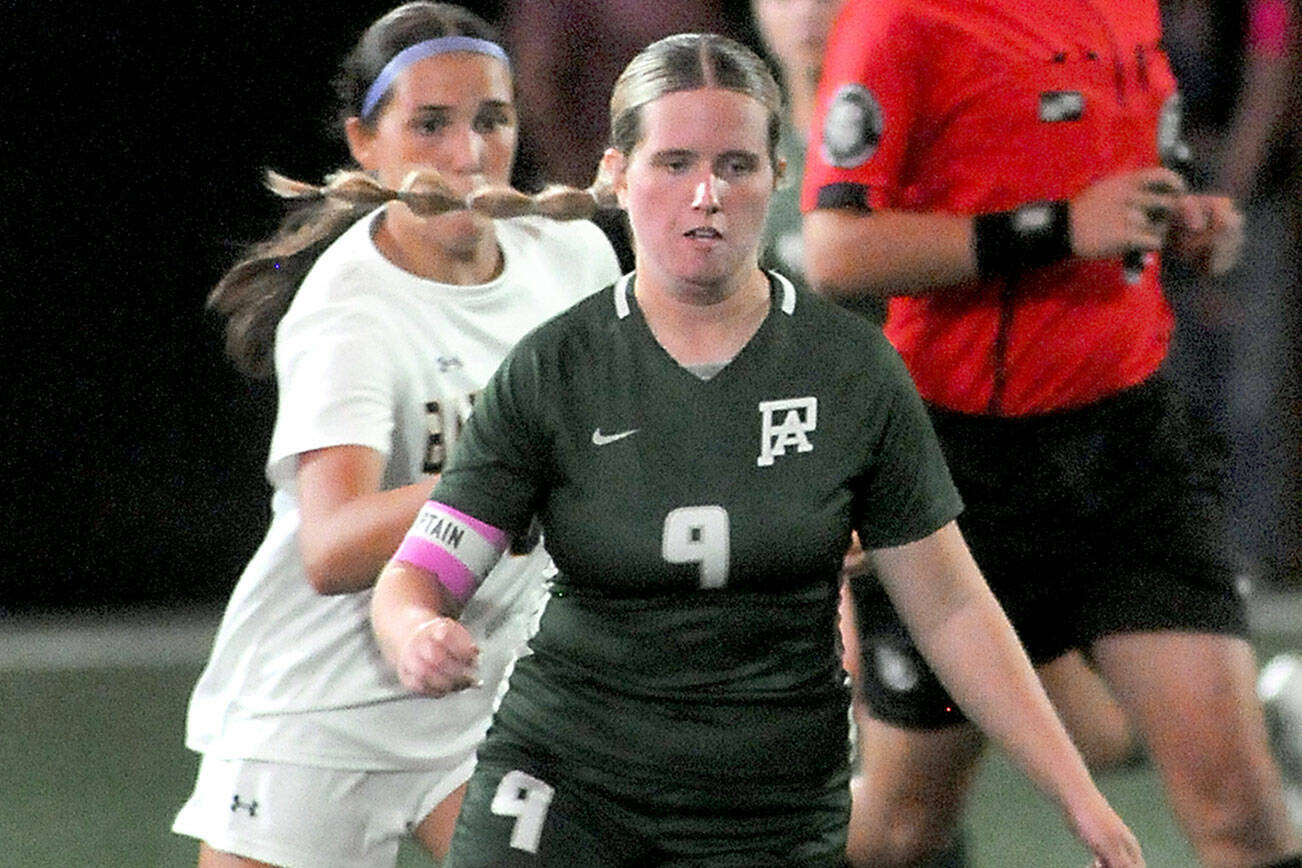 Port Angeles’ Allison Fricker, front, approaches the ball ahead of Bainbridge’s Isabella Saint Clair on Tuesday night at Peninsula College. (Keith Thorpe/Peninsula Daily News)