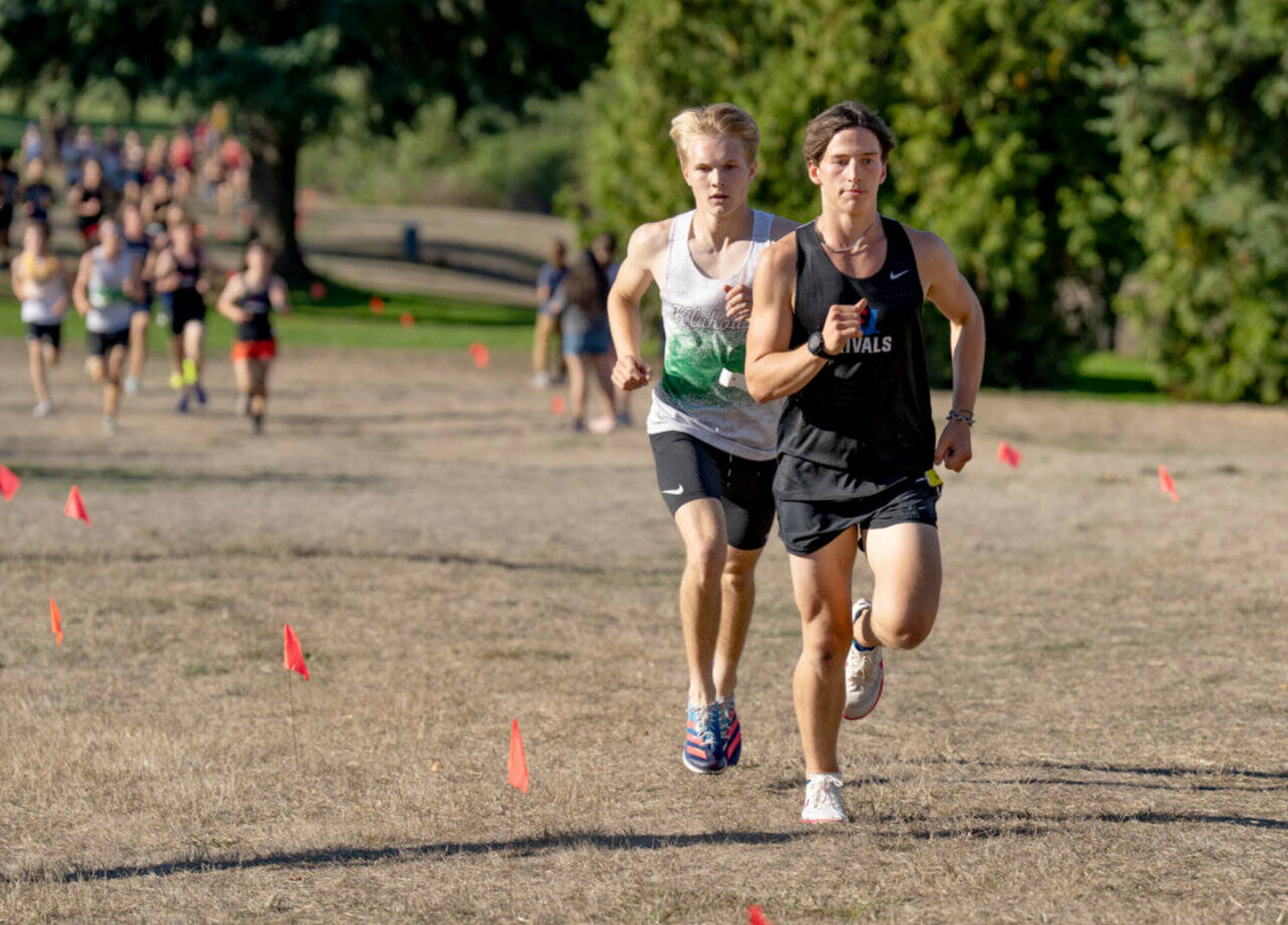 East Jefferson's Joshua Yearian leads Klahowya's Carson Wintch in a Nisqually League meet held at Camas Prairie Park on Tuesday. Yearian won the boys' race. (Steve Mullensky/for Peninsula Daily News)