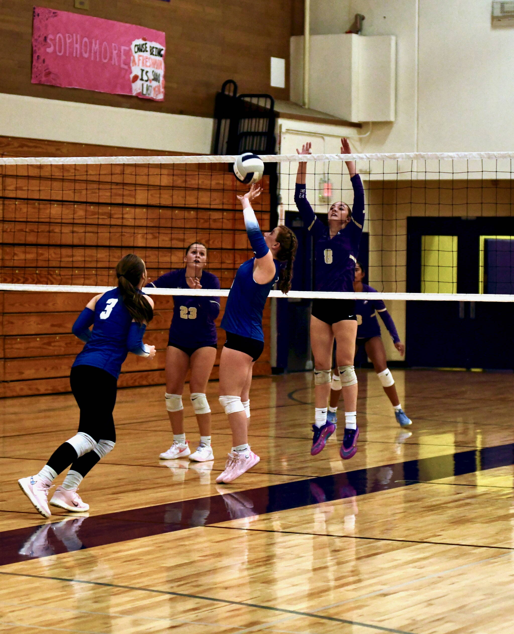 Jacques Star/Olympic Peninsula News Group
Sequim’s Rose Gibson, far right, is set to block defensively as Olympic setter Gwyn Rivaldi tips the ball up over the net during the Wolves’ 3-0 win over the Trojans on Tuesday.