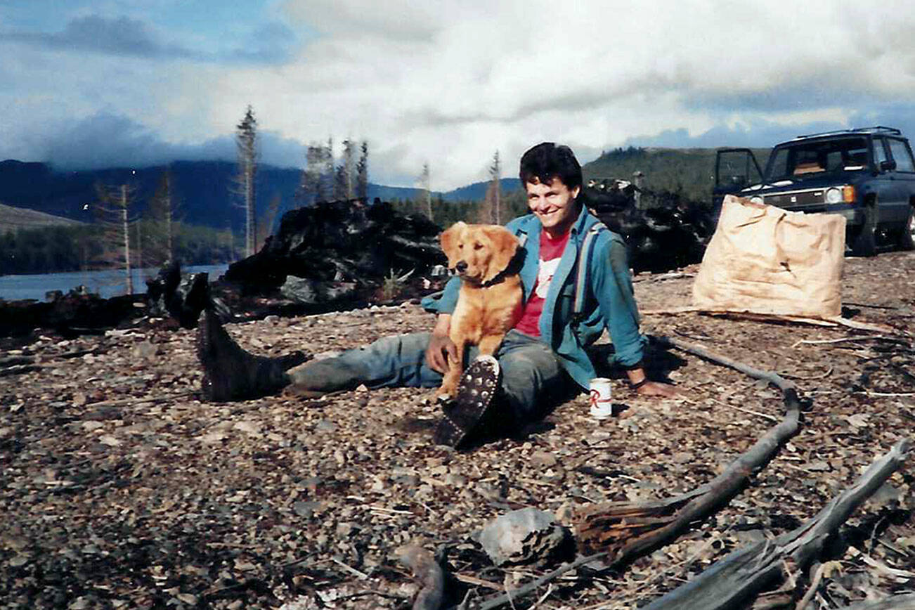Tom Swanson and his golden retriever, Tyler, during a Society of American Foresters replanting project at Lake Pleasant, five months after a 1985 fire that burned 550 acres on the West End and shut down U.S. Highway 101. (Courtesy photo)