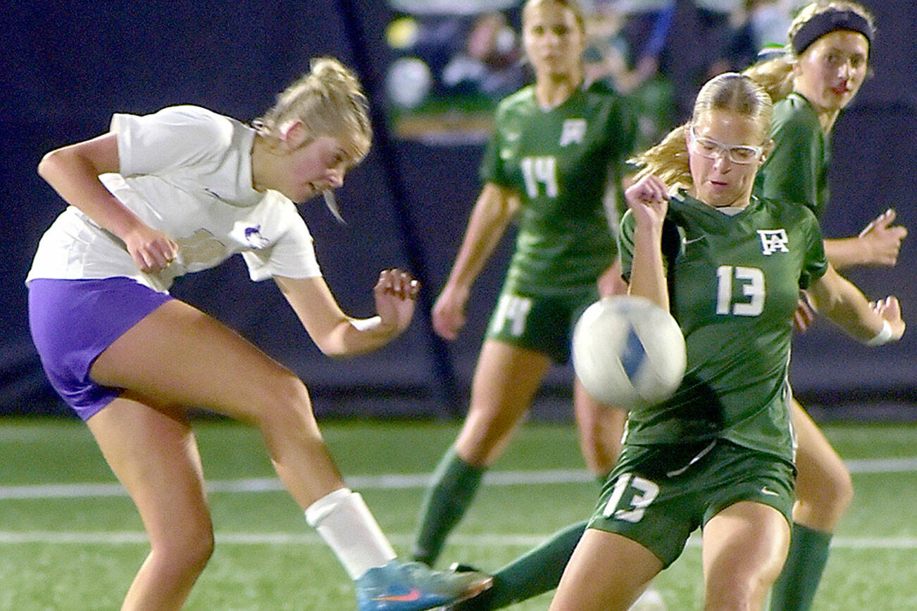 KEITH THORPE/PENINSULA DAILY NEWS
Sequim's (#10), left, passes the ball past Port Angeles' Brooke Pierce as Pierce's teammates Sophia Ritchie and Becca Manson prepare to give chase on Thursday in Port Angeles.