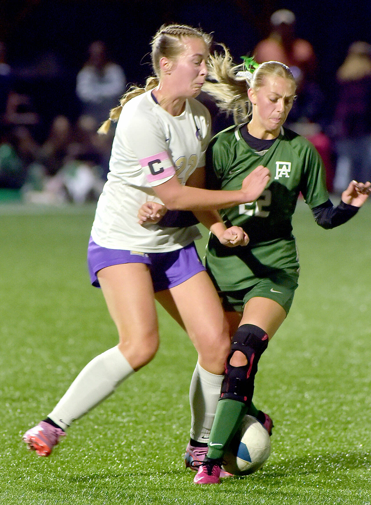 KEITH THORPE/PENINSULA DAILY NEWS Sequim’s Hailey Wagner, left, and Port Angeles’ Teanna Clark tangle for the ball on Thursday night at Peninsula College.