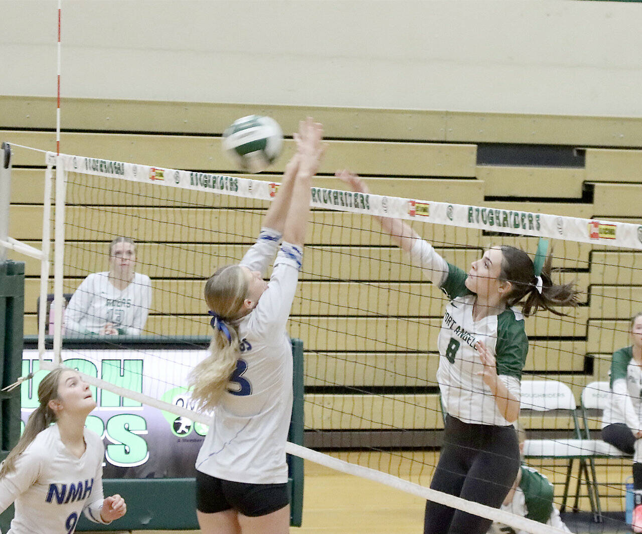 Port Angeles' Jordin Dunaway (8) hits a smash against the North Mason's Mari Morris and Sophia 
Sparks-Zabel (9). (Dave Logan/for Peninsula Daily News)