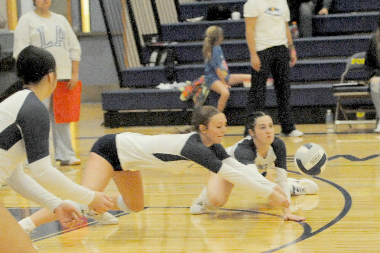 Forks’ Avery Dilley (center) and Chloe Gaydeski dig against Chief Leschi on Tuesday in Forks. The Spartans beat Chief Leschi 3-0. (Lonnie Archibald/for Peninsula Daily News)