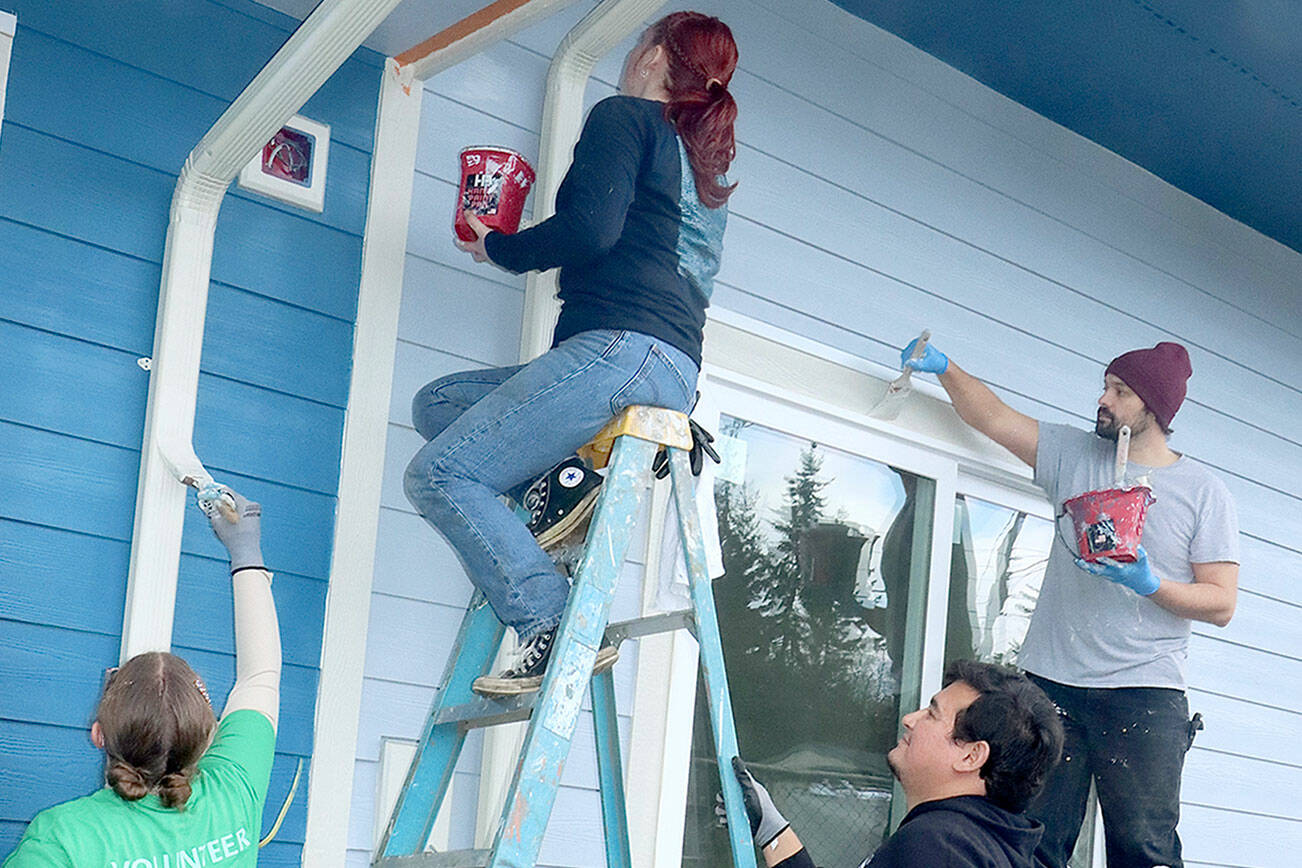 From left to right, Melissa Smith, Grace Possinger, Danny Vollin and Trevor Elder, First Fed employees at the Sixth Street branch in Port Angeles, volunteer to paint at the Habitat For Humanity Project on Wednesday at the corner of West Hazel Street and South Fairmount Avenue. About 14 bankers from two branches volunteered as part of the bank’s Community Spirit Month to paint the future home of the Ketchum Veteran Cottages. (Dave Logan/for Peninsula Daily News)
