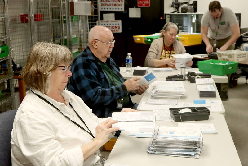 From left to right, Neva Miller, Ray Farrell, Shellie Andrews and Ryan O’Hara process election ballots on Tuesday morning at the Clallam County Courthouse in Port Angeles. Initial results were posted after press time and are available at www.peninsuladailynews.com. For full coverage, see Thursday’s print and online editions. (Dave Logan/for Peninsula Daily News)