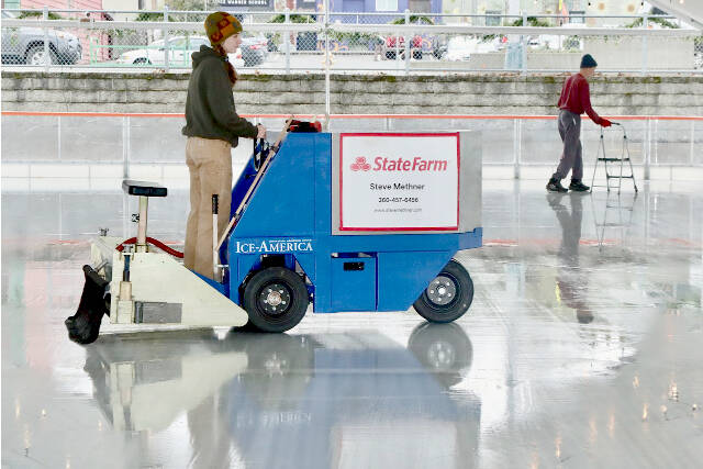 Volunteer Laken Folsom runs the ice resurfacing machine in preparation for opening day on Friday at the Winter Ice Village in Port Angeles. (Dave Logan/For Peninsula Daily News)