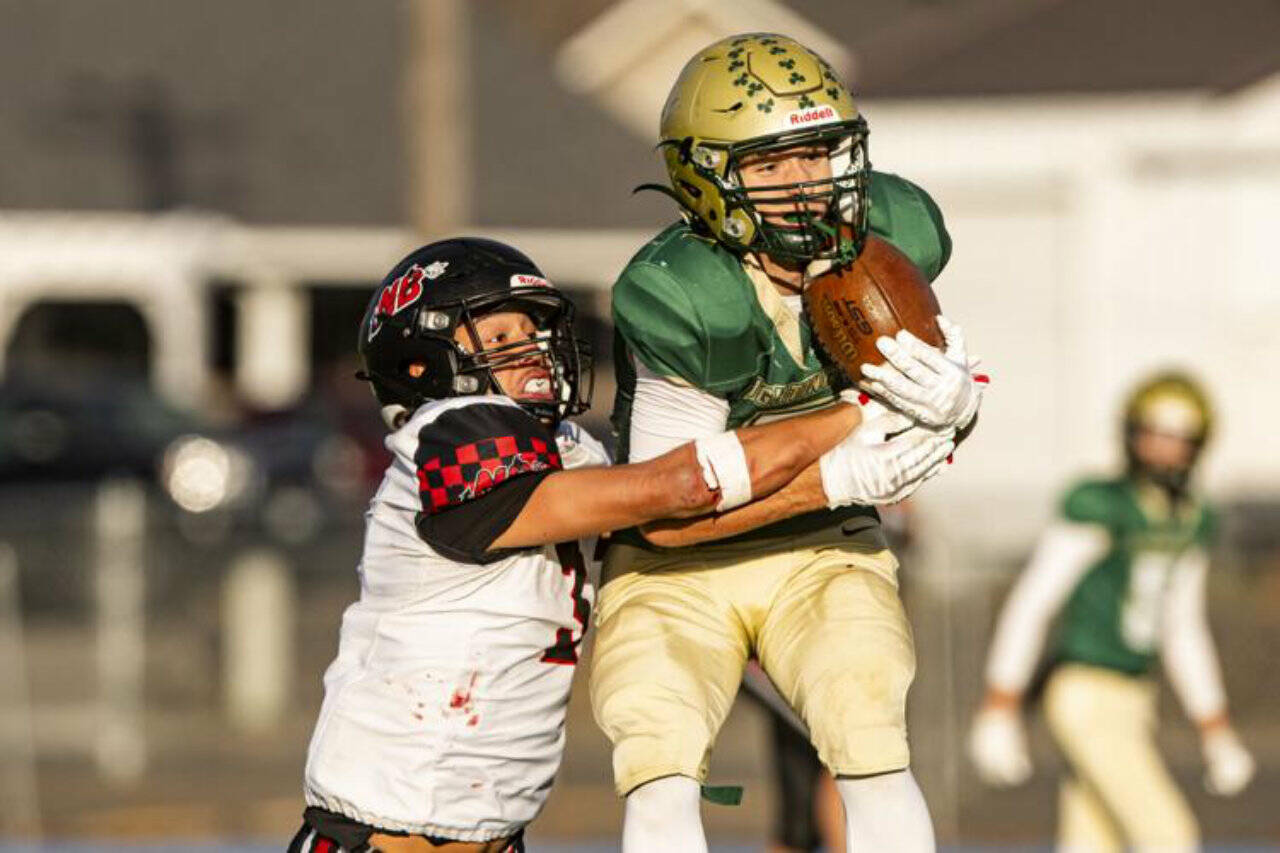 DeSales’ Maddox Filan catches a pass from quarterback Cohen Wood before Neah Bay’s Caleb Cummins tackles him during their 2025 their class 1B championship football quarterfinal at Walla Walla High School on Saturday. Neah Bay stayed close to DeSales until the fourth quarter when the Fighting Irish scored 22 straight points to win 58-24. Neah Bay, which traveled 1,830 miles to play its two state playoff games in Colfax and Walla Walla, finished its season with an 8-3 record. (Kezia Setyawan/Walla Walla Union-Bulletin)