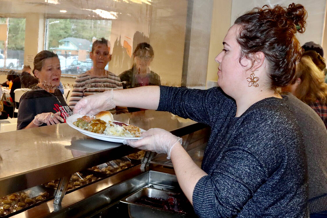Volunteer Rachel Heath helps serve a full Thanksgiving meal at the Salvation Army Pantry on Wednesday.  (Dave Logan/for Peninsula Daily News)