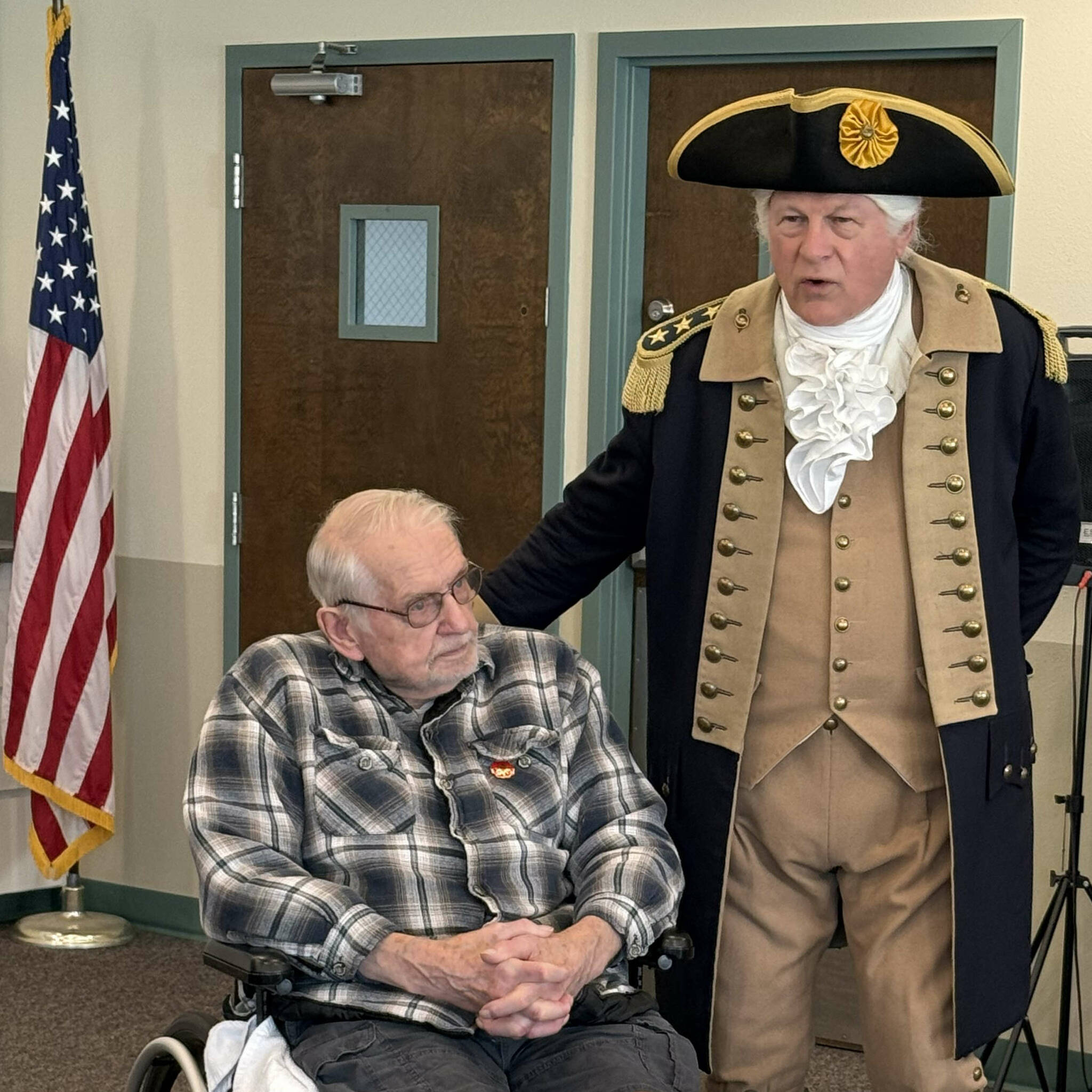 Vern Frykholm, who has made more than 500 appearances as George Washington since 2012, visits with Dave Spencer. Frykholm and 10 members of the New Dungeness Chapter, NSDAR, visited with about 30 veterans on Nov. 8, just ahead of Veterans Day. (New Dungeness Chapter DAR)