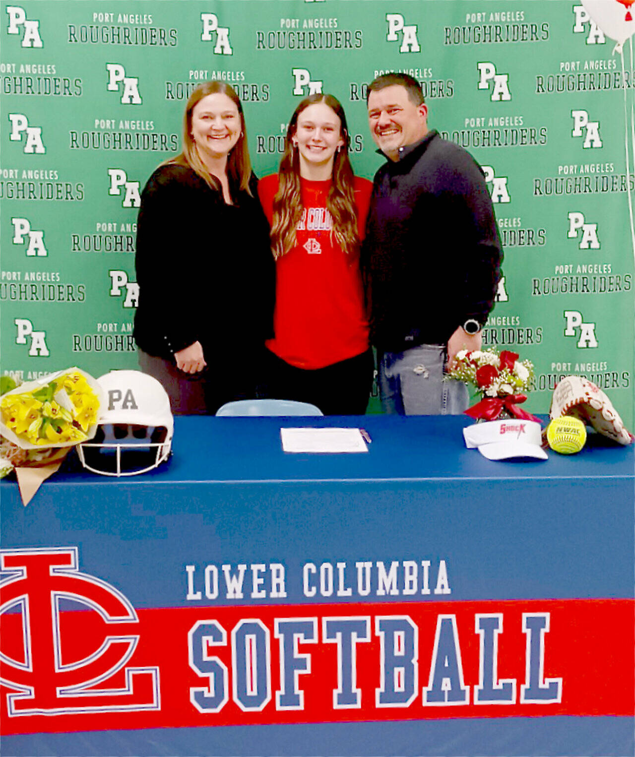 Lynzee Reid with her parents Tammy Reid and Jason Reid during her signing ceremony to play softball at Lower Columbia College. (Pierre LaBossiere/Peninsula Daily News)